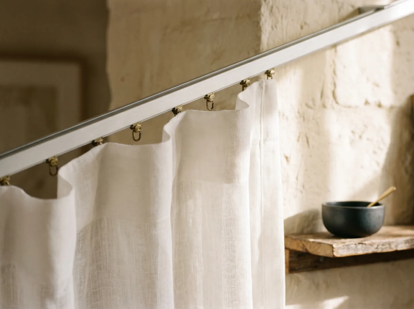Close detail of white voile in even S-fold waves on a slim ceiling track